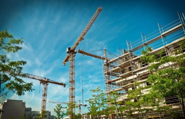 a building site with 3 cranes
