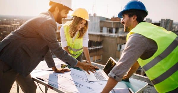 3 People Analyzing Construction Plans