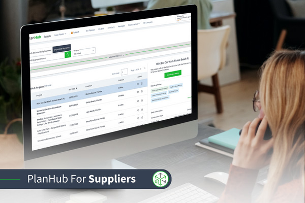 A supplier is sitting in front of the computer, using PlanHub.