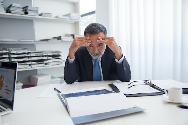 Office worker reading papers.