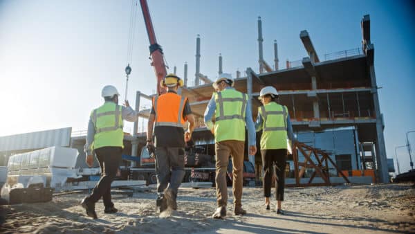 4 men in front of a construction site