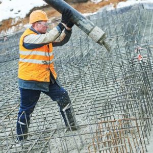 Construction worker pouring concrete.